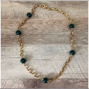 Gold plated and hunter green beaded, long necklace.